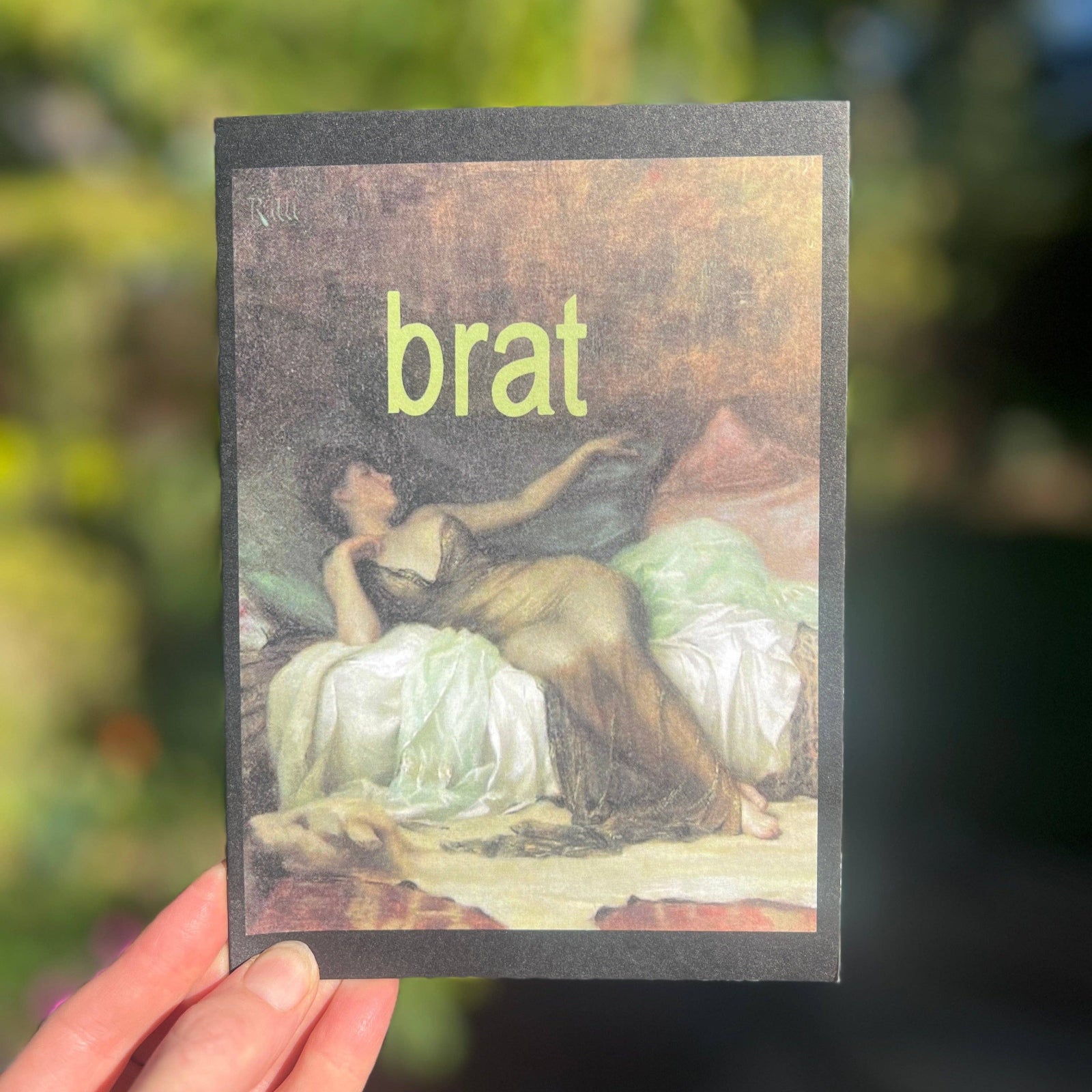 Someone holding the brat brat Nouveau Greeting Card.