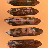 5 red moss agate on an orange background