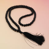 Black Obsidian 108 Mala Necklace on pink and orange background