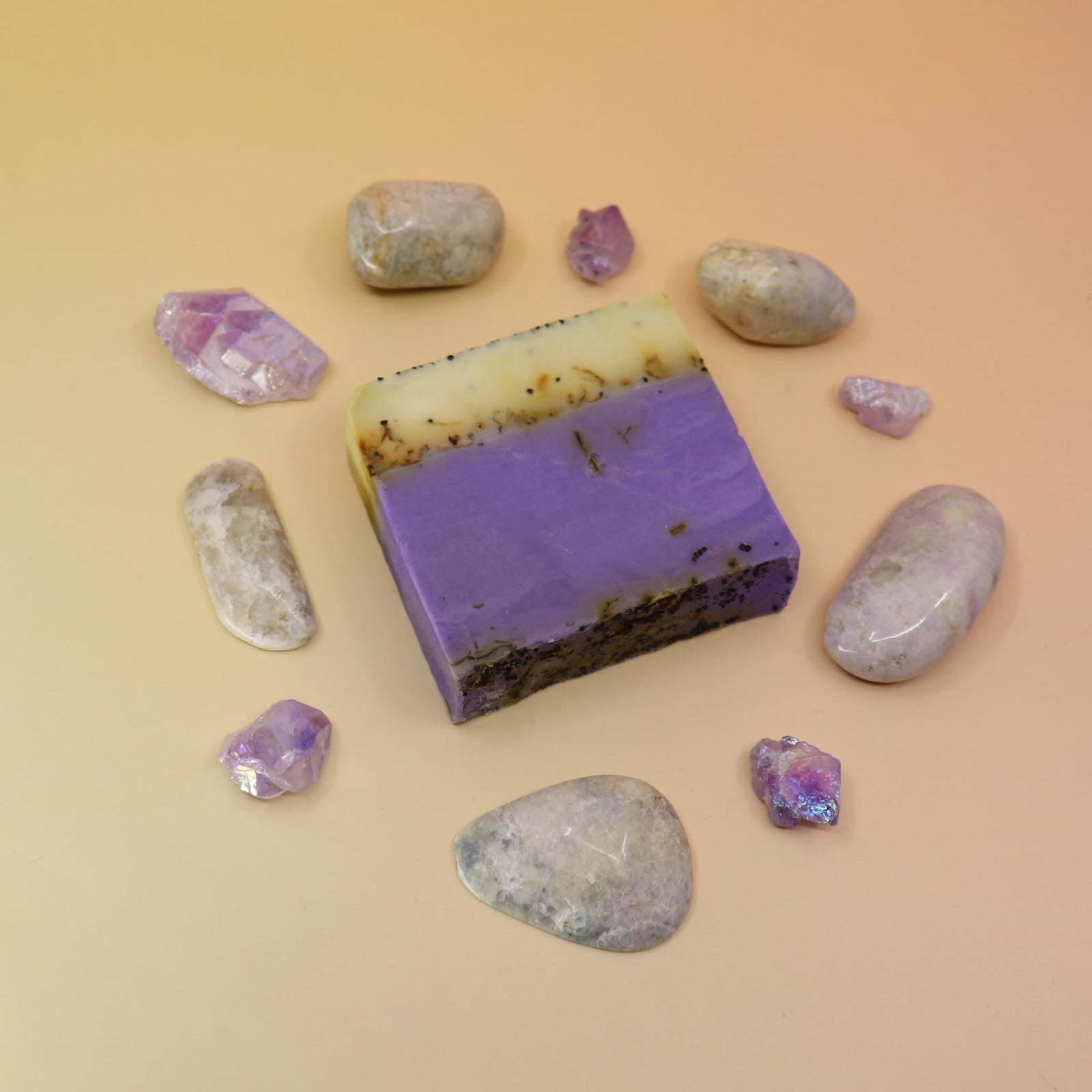 Purple soap bar with natural stones on a beige background