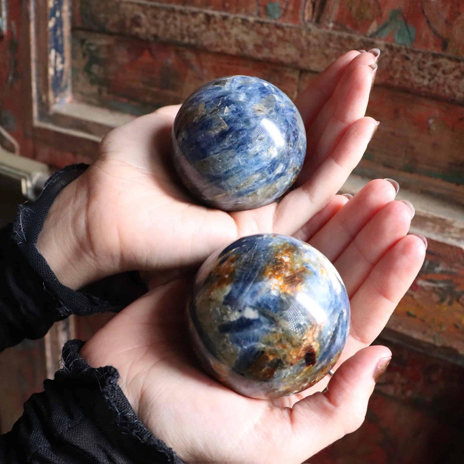 Two Blue Kyanite spheres with golden and green inclusions