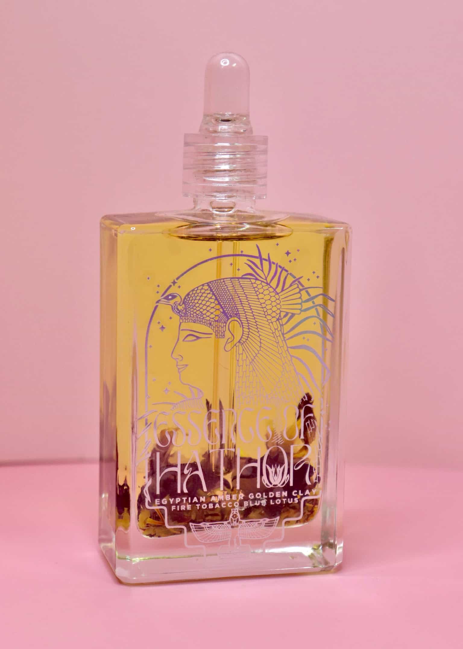 Glass jar of Blue Lotus Oil Ritual with full lotus flower inside