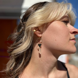 A woman wearing the Brass Quartz Crystal Triangle 2 inch. Earrings.