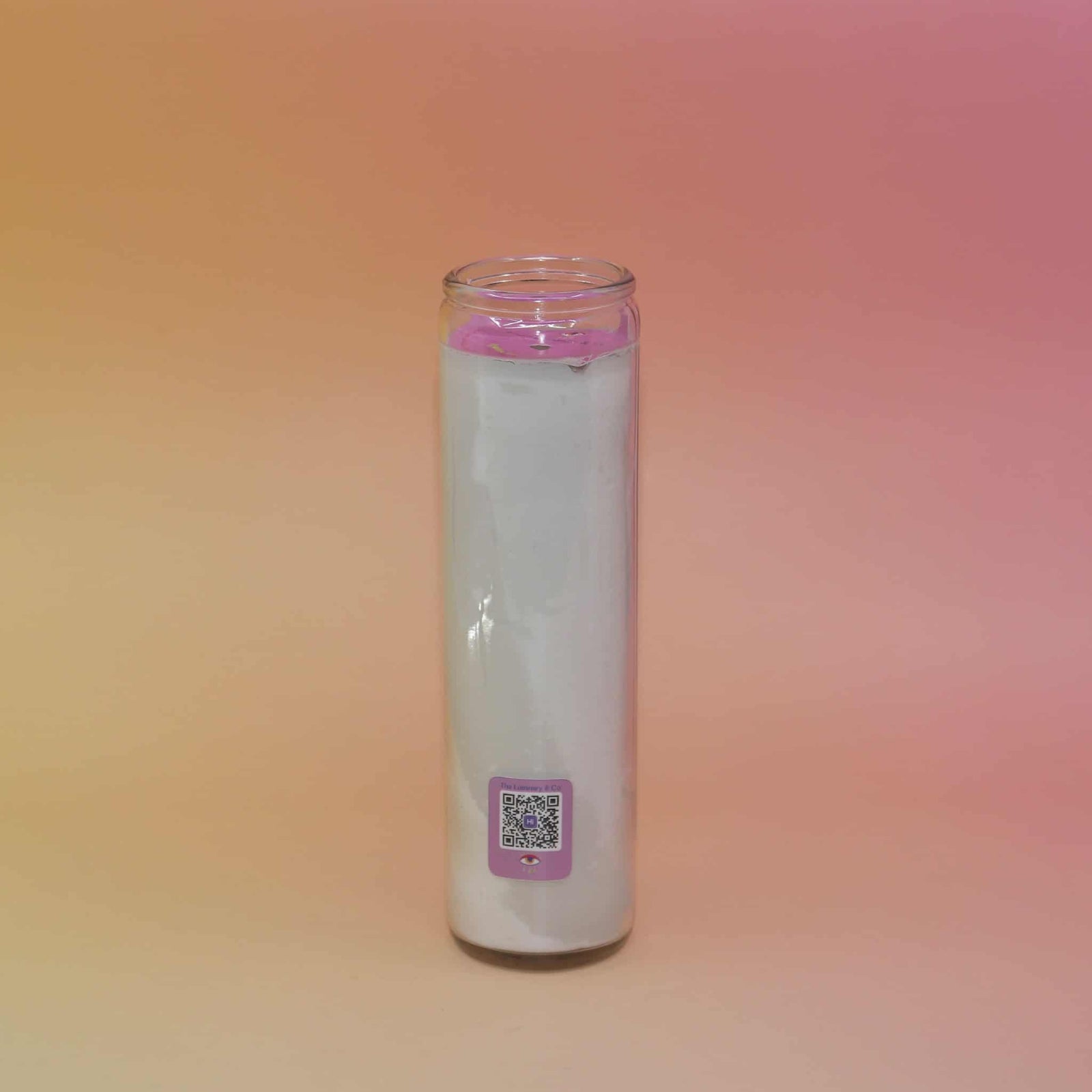 Glass candle with a pink cap on a gradient background