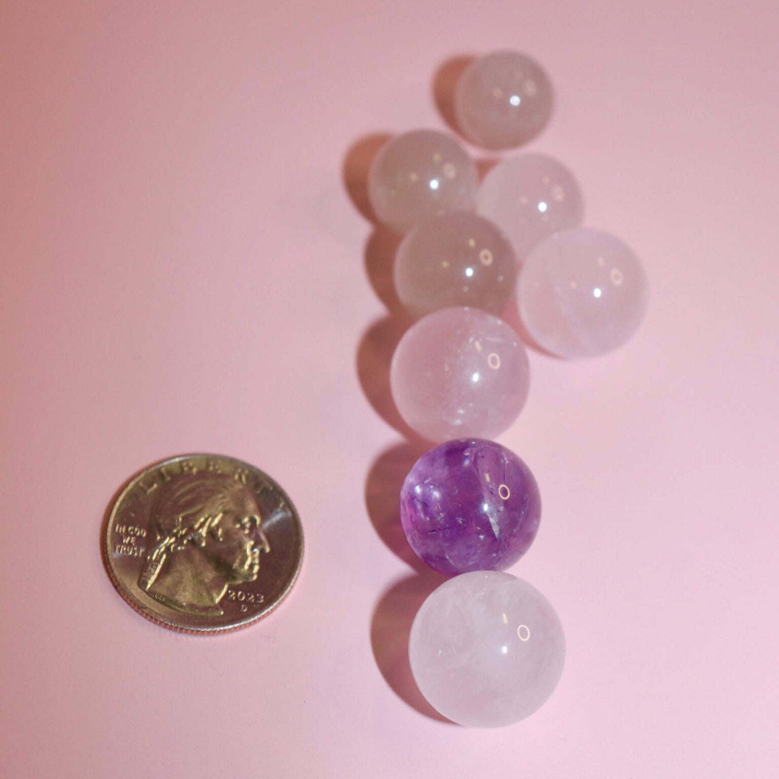 Picture of crystal marbles with quarter or size reference