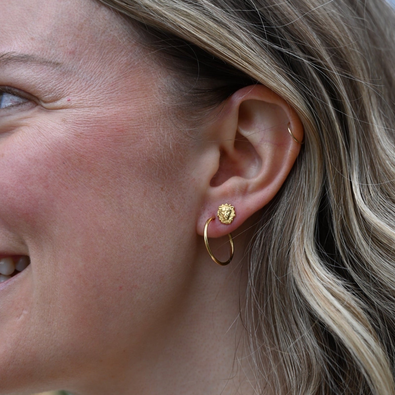 Someone wearing the gold Vintage Endless Hoops Earrings.