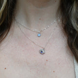 Someone wearing the Sterling Silver Purple Evil Eye Necklace with Paperclip Chain.