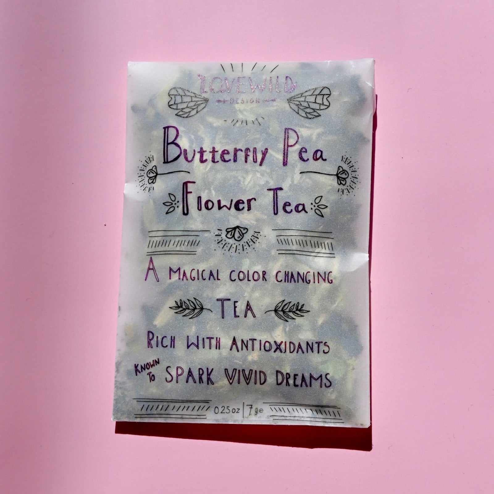 The Butterfly Pea Flower Tea on a pink background.