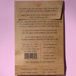 The back of the Gleaming Glow Clay Face Mask on a pink background.