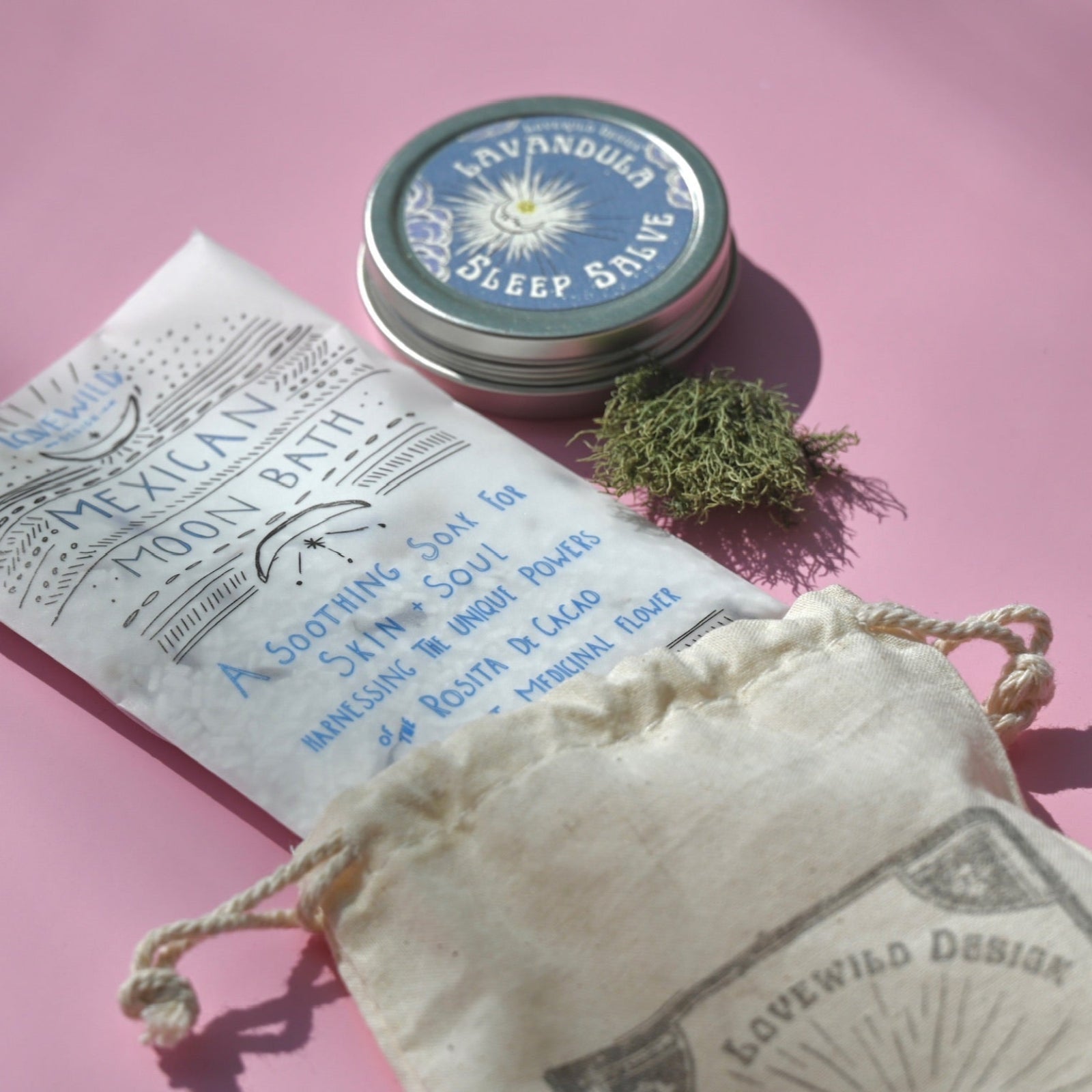 The contents of the Easy Sleep Gift Set lying on a pink background.