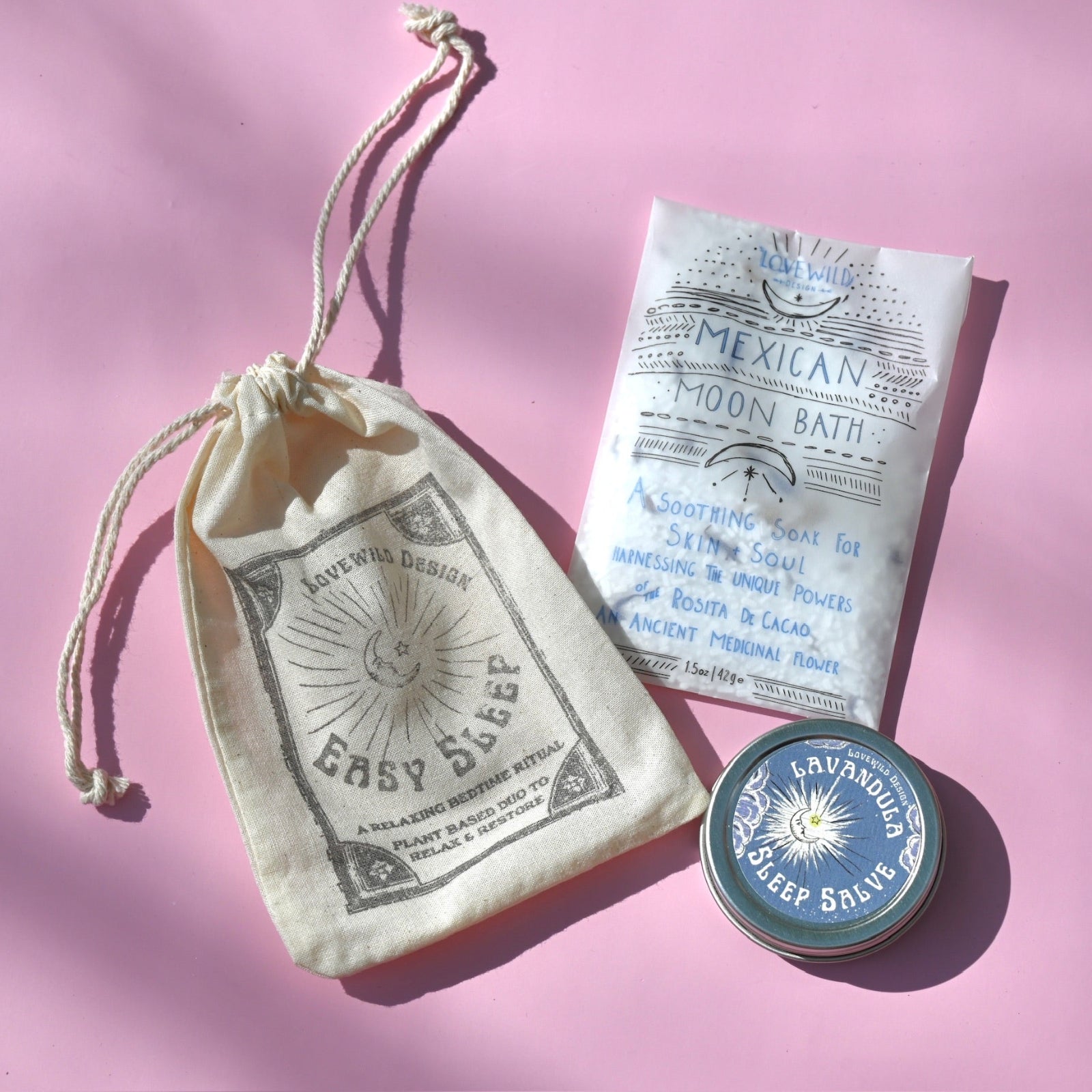 The contents of the Easy Sleep Gift Set lying on a pink background.