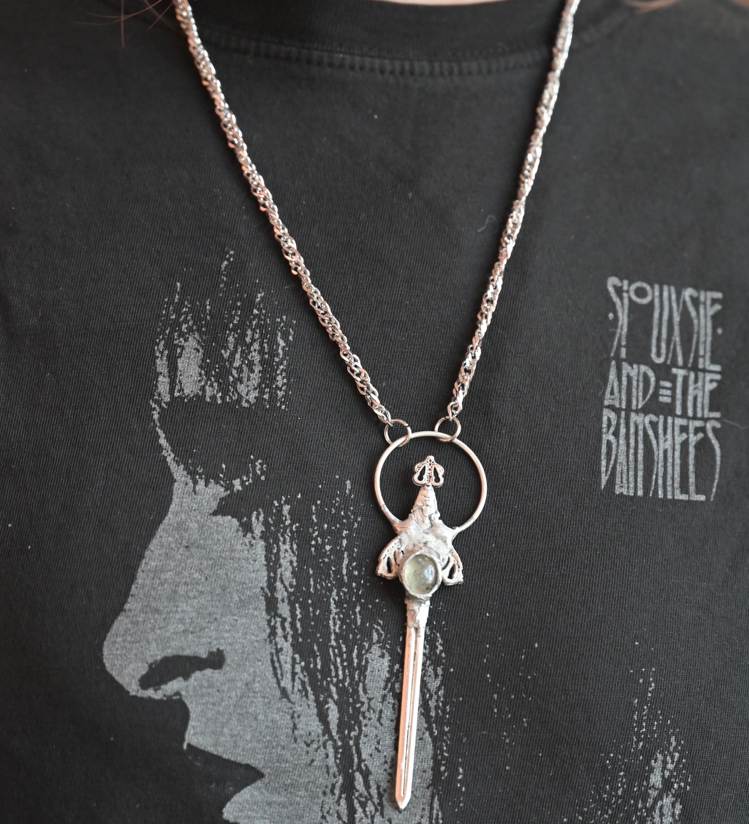Someone wearing the Sterling Silver Prehnite Sword Necklace.