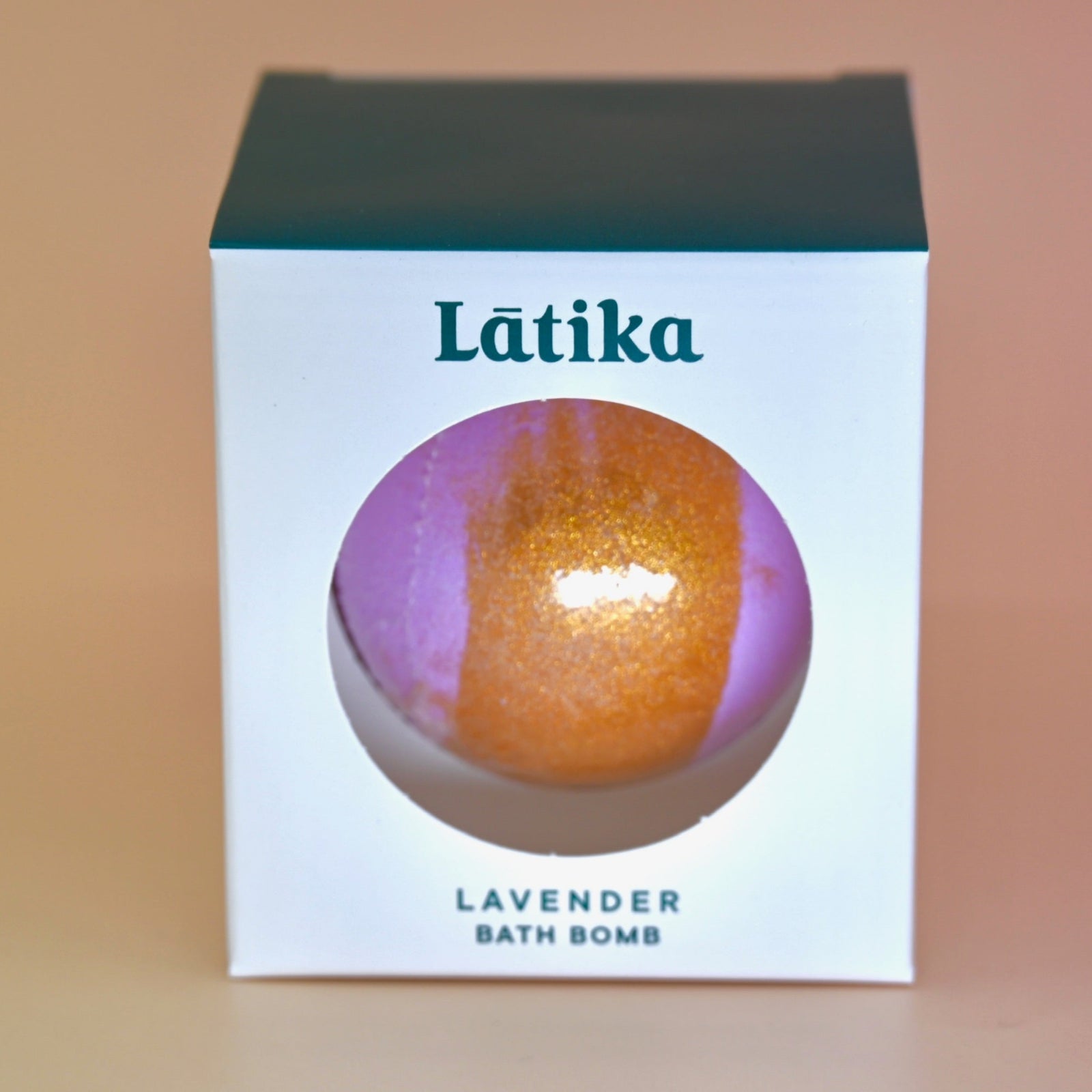 The Hand-Painted Lavender Bath Bomb on a dusty pink background.