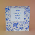 The White Tea Shower Steamers - 4 Pack Shower Steamers on a pink background.