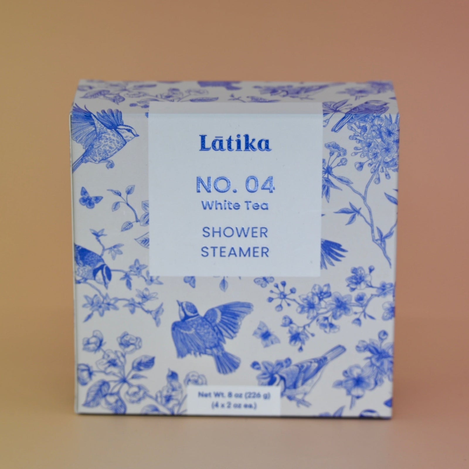 The White Tea Shower Steamers - 4 Pack Shower Steamers on a pink background.