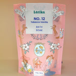 The Tobacco-Vanilla Vegan Bath Soak on a dusty pink background.