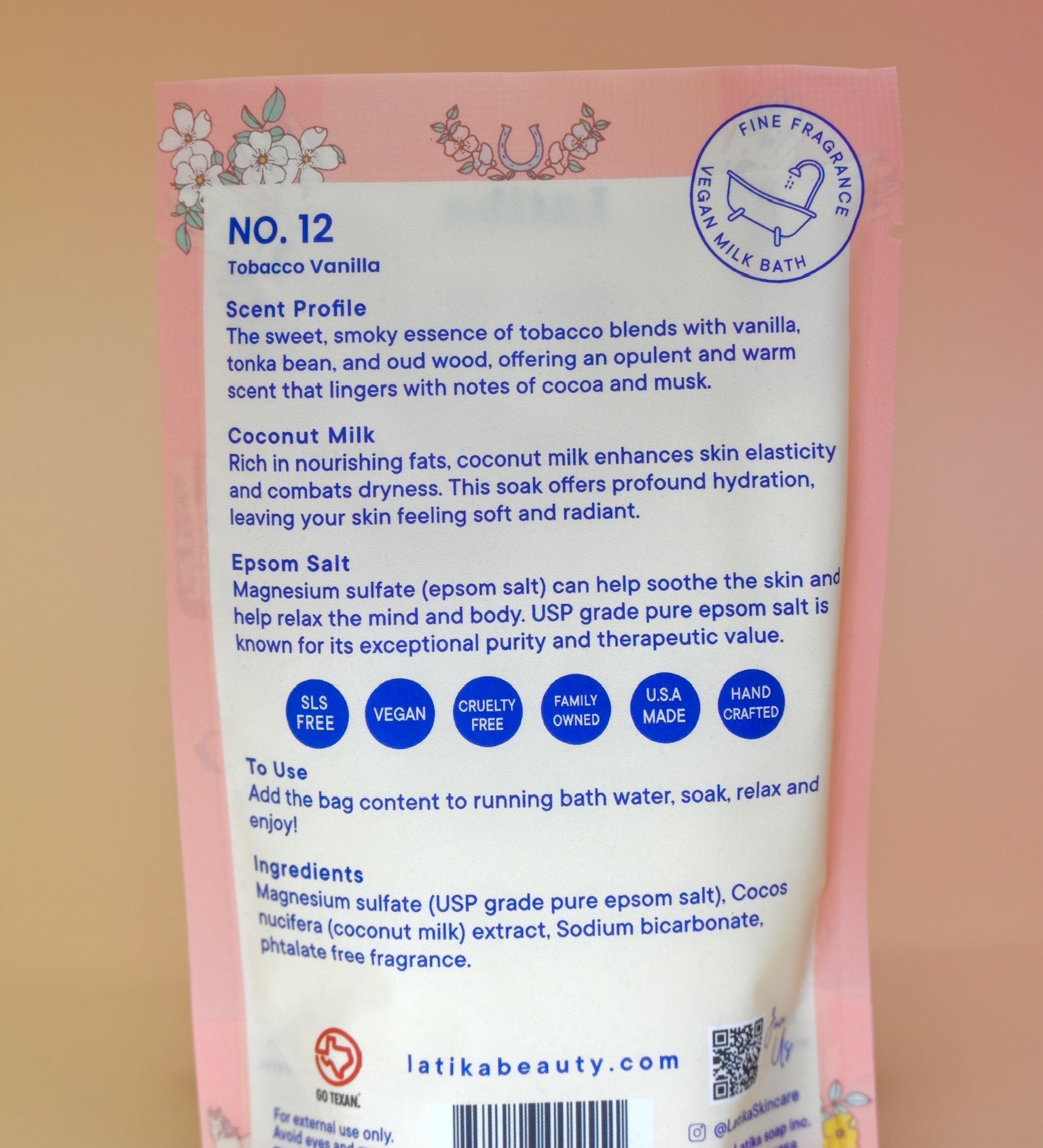 The back of the Tobacco-Vanilla Vegan Bath Soak on a dusty pink background.