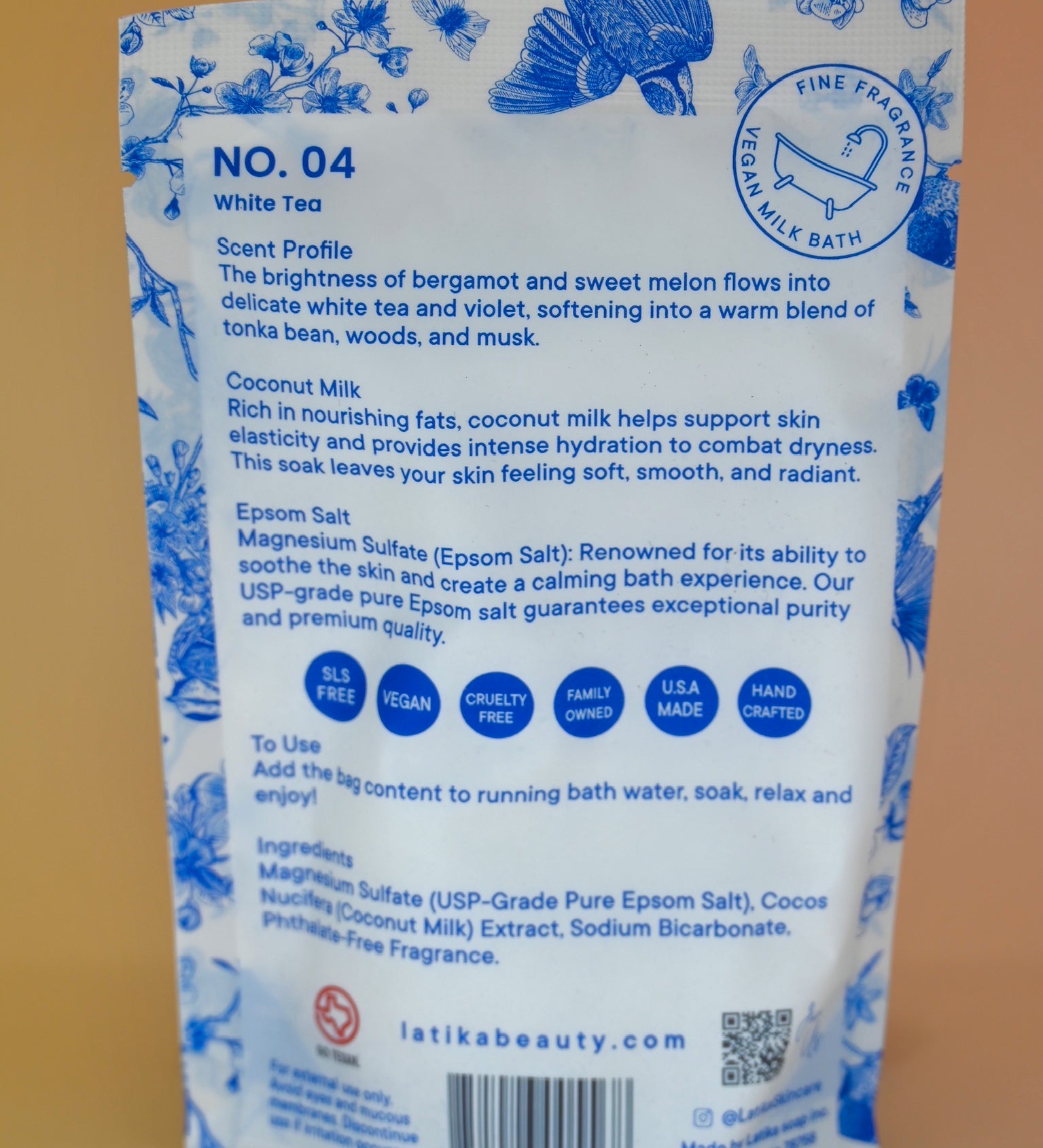 The back of the White Tea Milk Bath Soak on a dusty pink background.