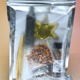 The back of the Send It Back Reversing Spell Kit - Reversing Ritual Kit on a pink and yellow background.