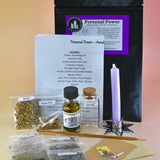 The Personal Power Ritual and Bottle Spell Amulet Kit on a pink and yellow background with all its contents out as well.