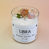 The Libra Zodiac Crystal Candle on a peach colored background.
