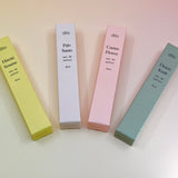 All of the travel sprayer dilo perfumes on a light pink background.