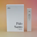The box of the Palo Santo 15ml Unisex Eau de Parfum Travel Sprayer and the regular size on a light pink background.