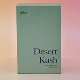 The box of the Dilo Desert Kush 50ml Unisex Eau de Parfum on a pink background.