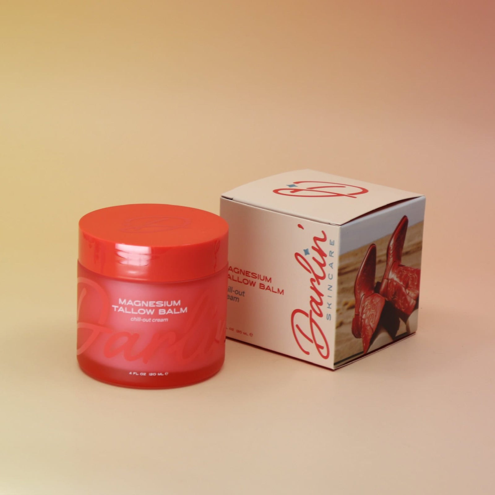 Red jar of balm with packaging on a gradient background
