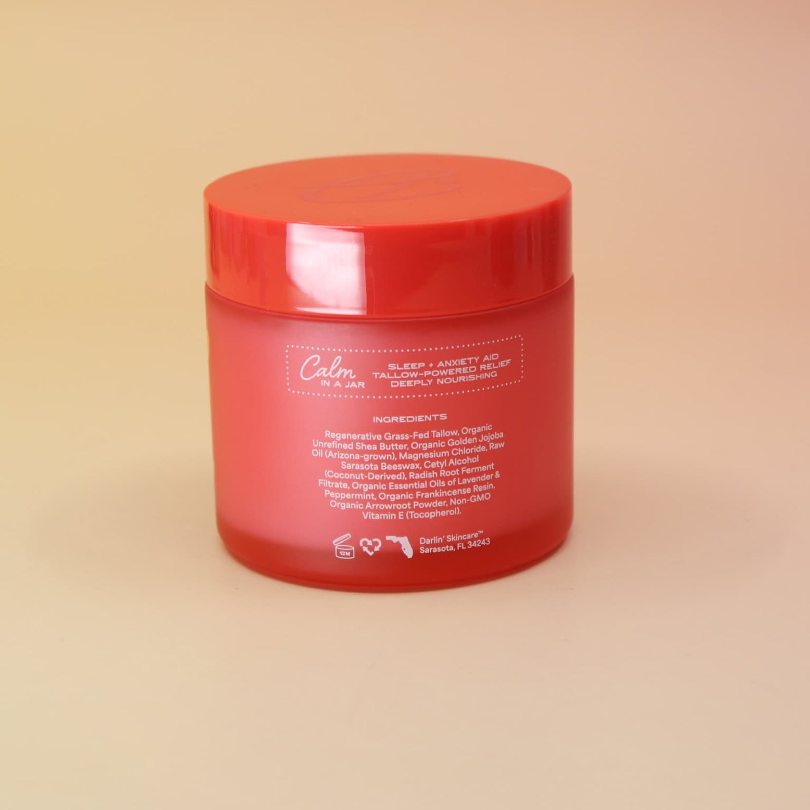 Red jar with a label on a beige background