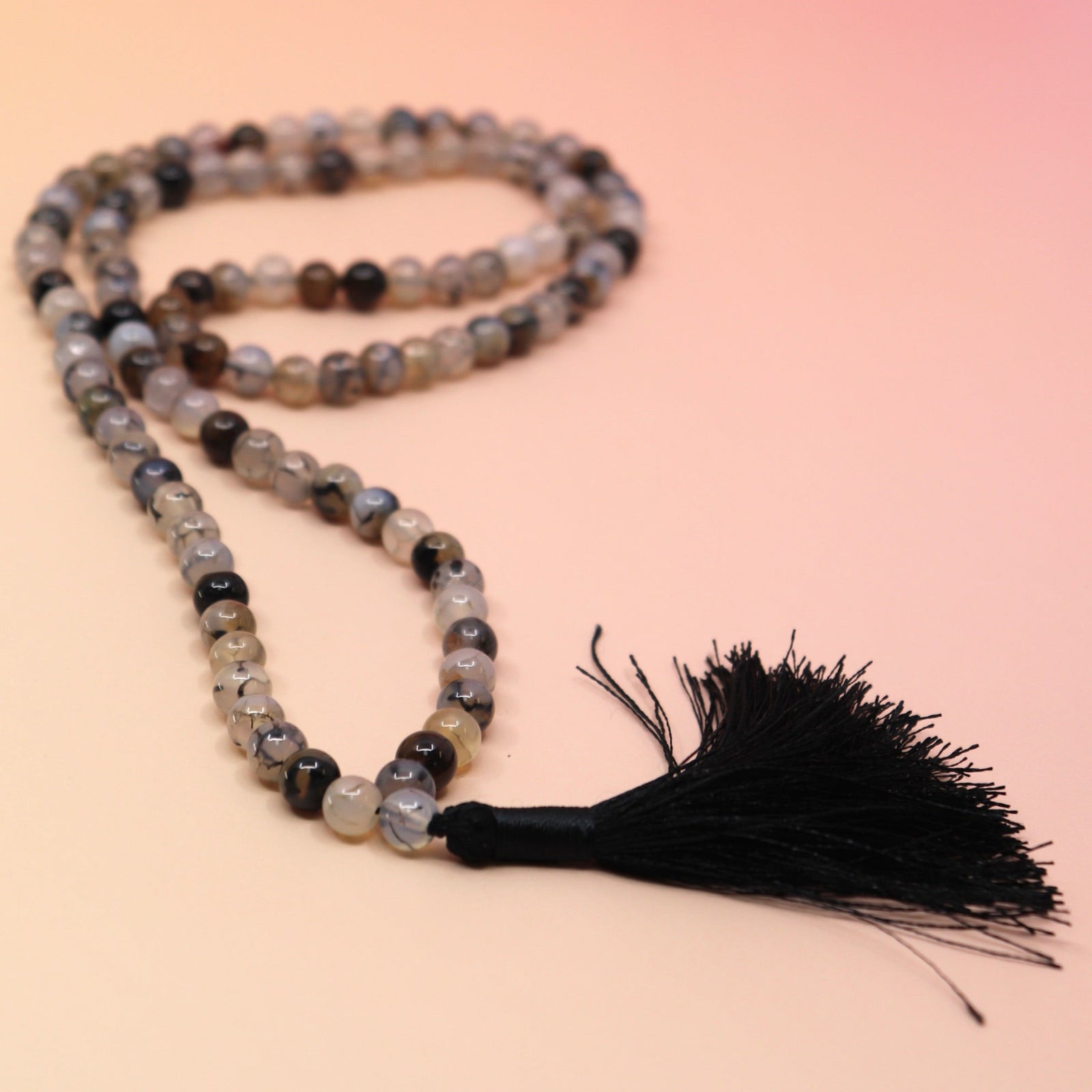 Dragon Vein Jasper 108 Mala Necklace on pink and orange background