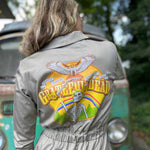 Person wearing a jacket with a 'Grateful Dead' logo in front of a vintage van.