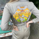 Person wearing a beige jumpsuit with a Grateful Dead logo on the back.