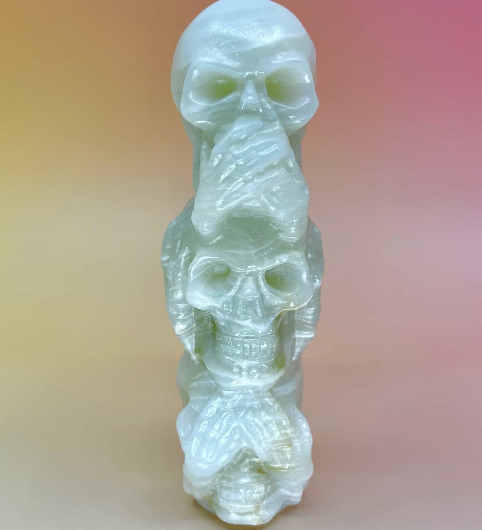 Front view of skulls covering eyes, ears, and mouth (see/hear/speak no evil)
