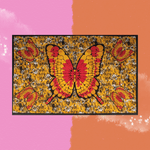 The Golden Butterfly Cotton Tapestry on a pink and orange background.