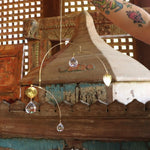 Someone holding the Prisma Hanging #15 in front of a wooden background.