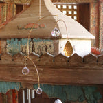 Someone holding the Prisma Hanging #15 in front of a wooden background.