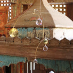 Someone holding the Prisma Hanging #15 in front of a wooden background.