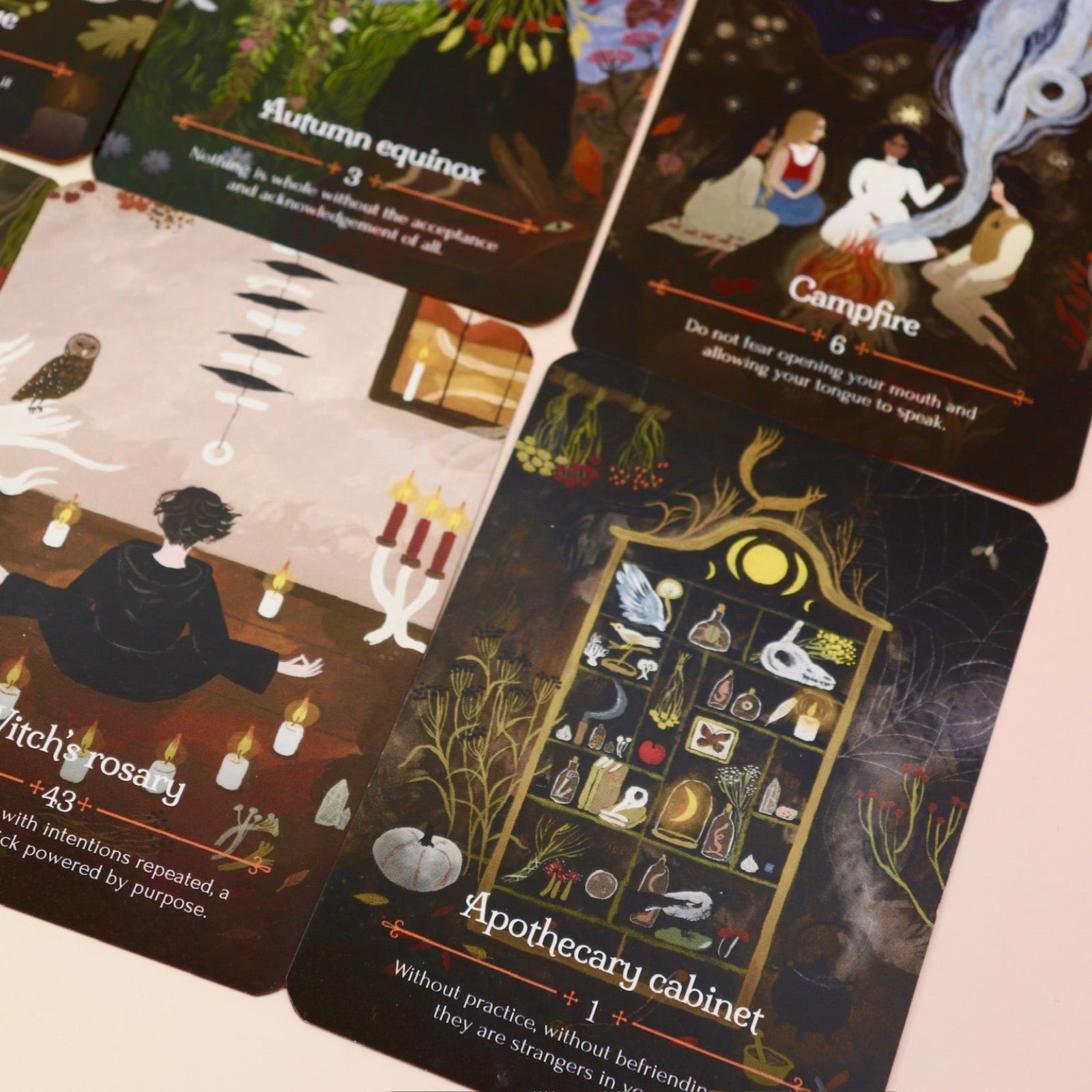 The Seasons of the Witch - Mabon Oracle Card Deck on a pink and yellow background.