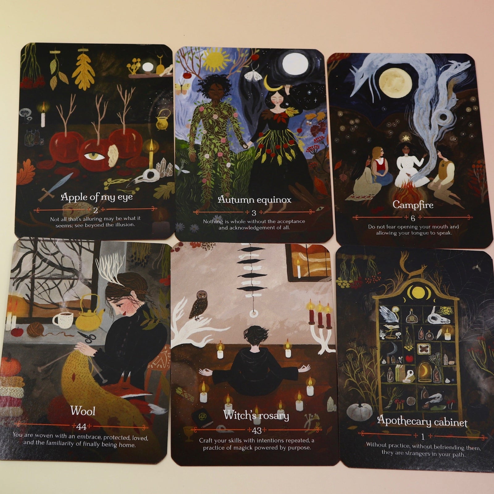 The Seasons of the Witch - Mabon Oracle Card Deck on a pink and yellow background.
