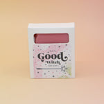 The Good Witch Wicked Themed 4 oz Bar Natural Soap on a pink and yellow background.