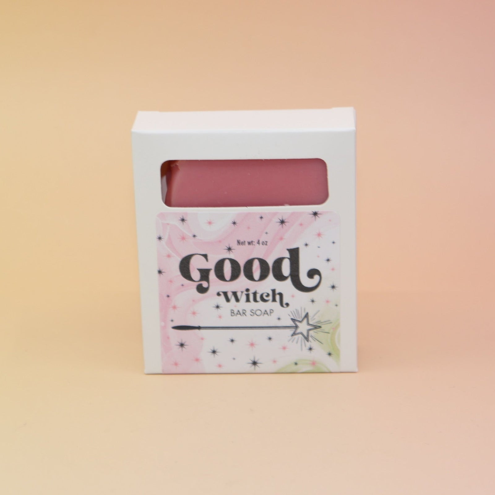 The Good Witch Wicked Themed 4 oz Bar Natural Soap on a pink and yellow background.