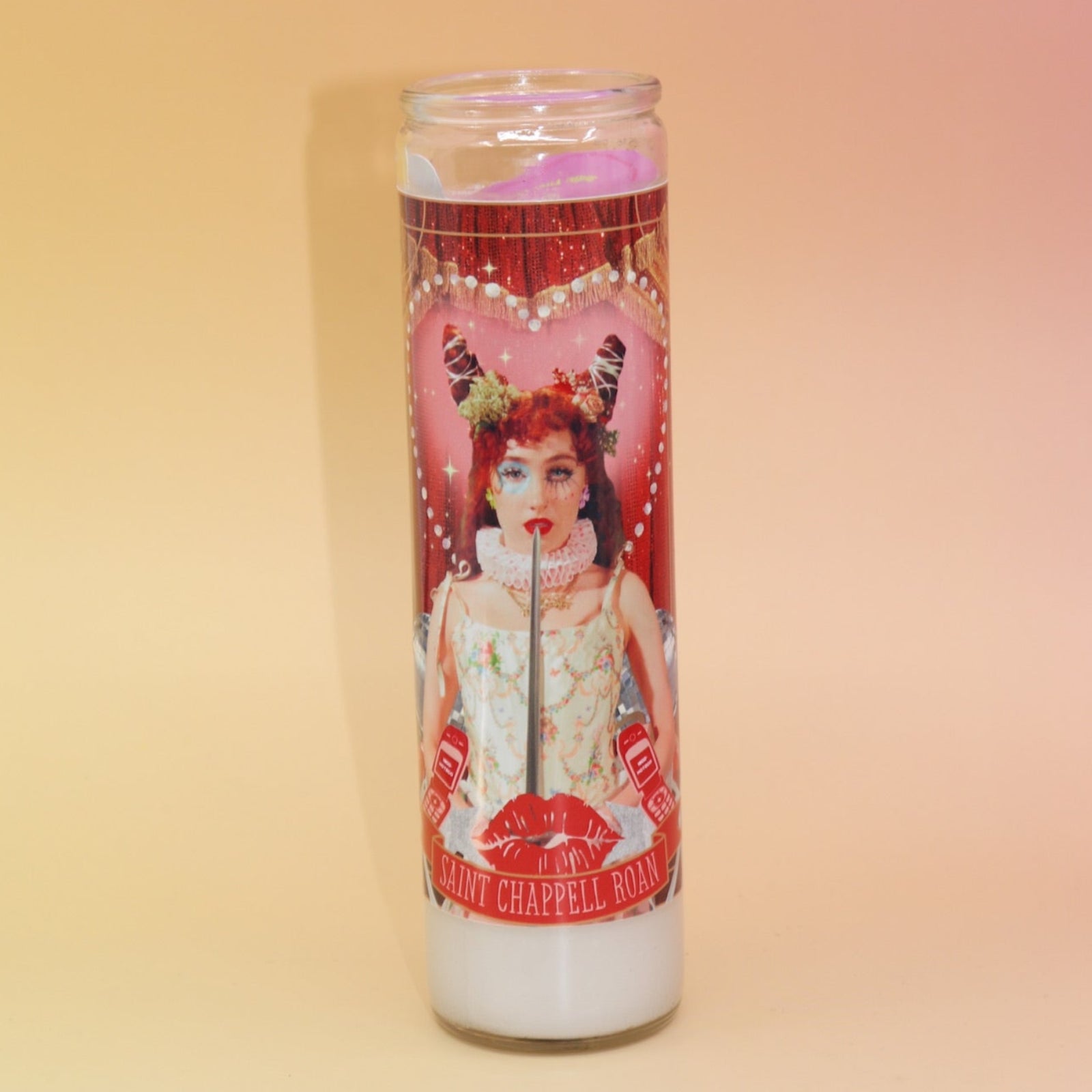 The Chappell Roan Altar Candle on a pink and yellow background.