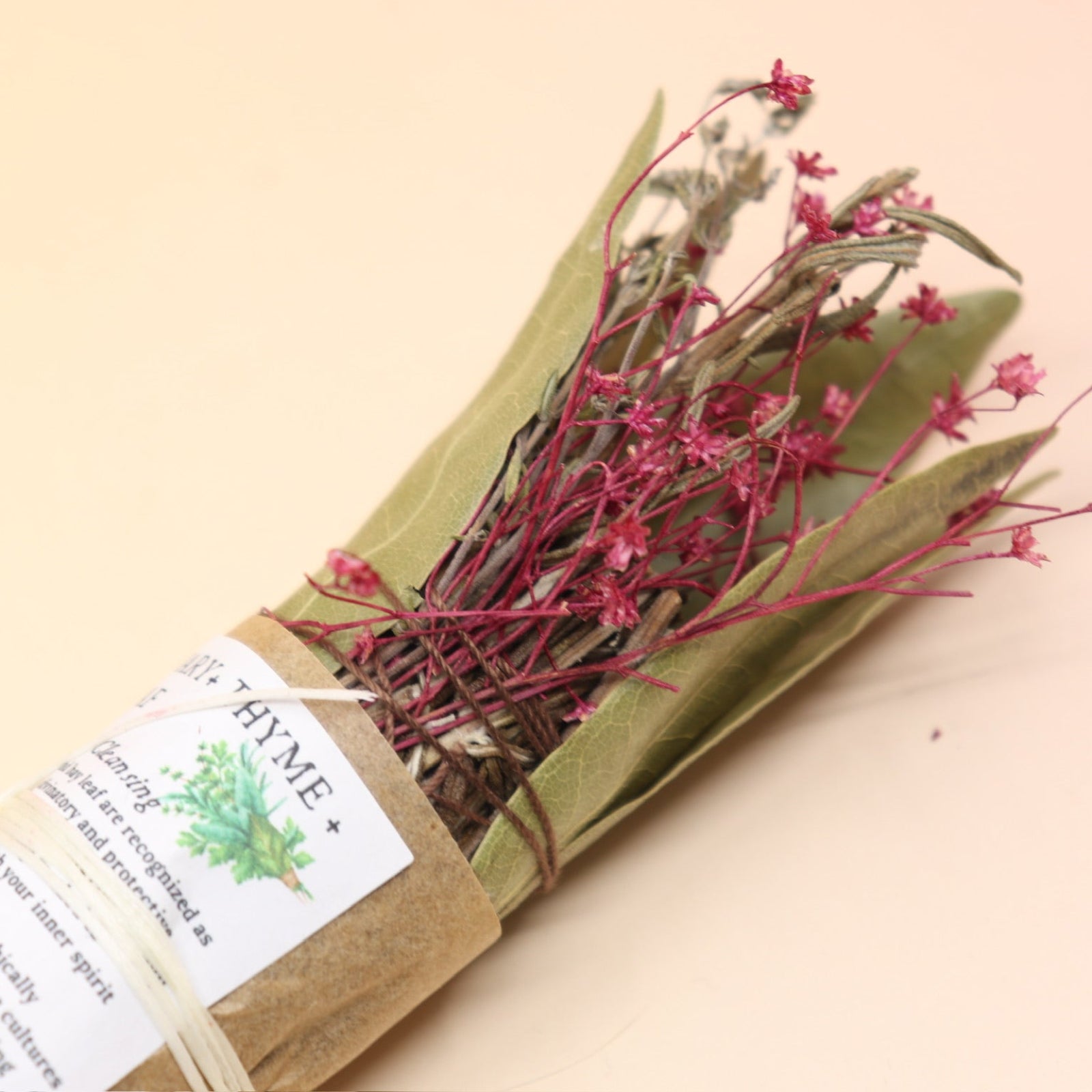 The Rosemary Smoke Cleansing Bundle on a pink and yellow background.