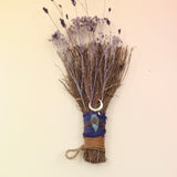 The Moon Besom Broom with Clear Quartz on a pink and yellow background.