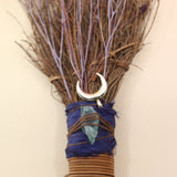 The Moon Besom Broom with Clear Quartz on a pink and yellow background.