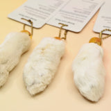 Three of the Lucky Rabbit's Foot on a pink and yellow background.