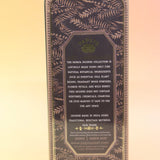 The Earth Dust Premium Incense on a pink and yellow background, showing off the back.