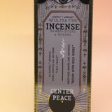 The Center Peace Premium Incense on a pink and yellow background.