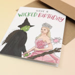 The Have A Wicked Birthday Card and its envelope on a pink and yellow background.